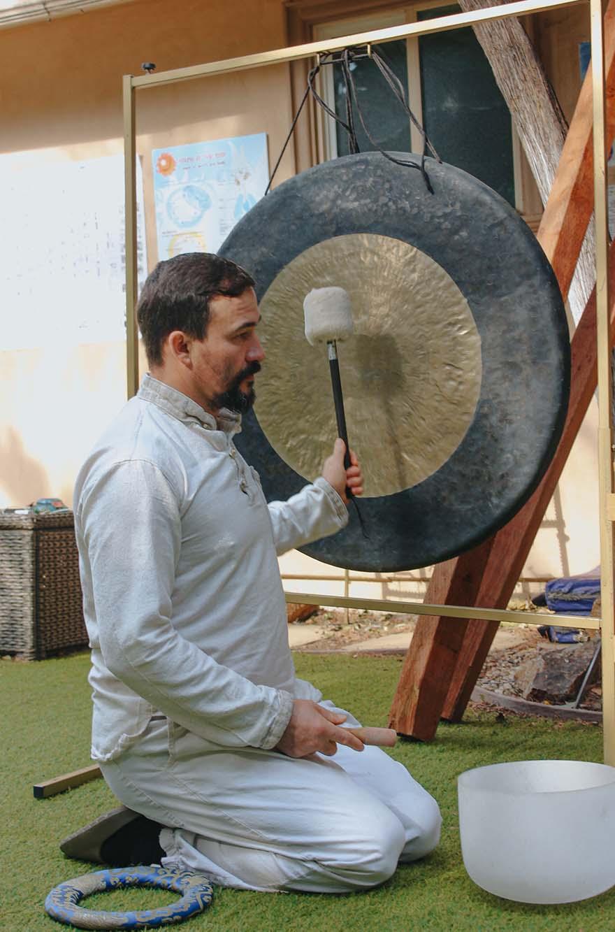 Participants experiencing emotional release during a Fire Cleansing Ritual, with flickering flames creating a serene atmosphere