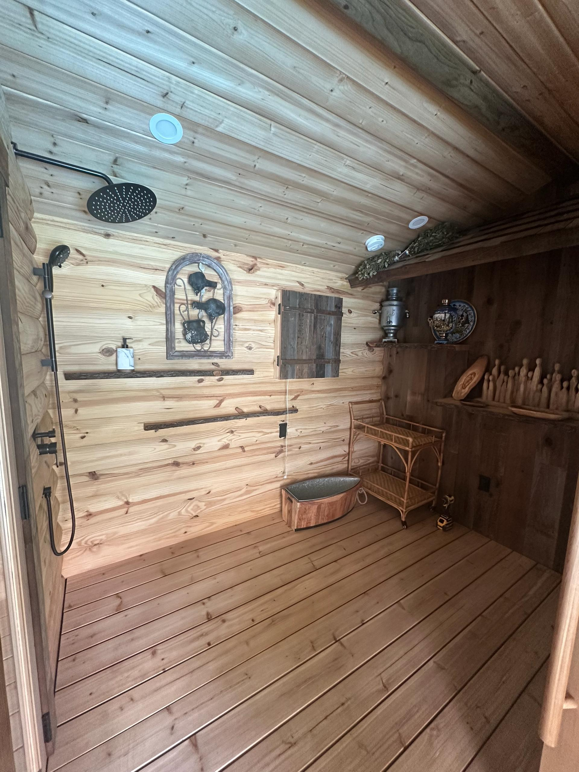 Traditional wooden sauna interior with benches and lighting in Woodland Hills