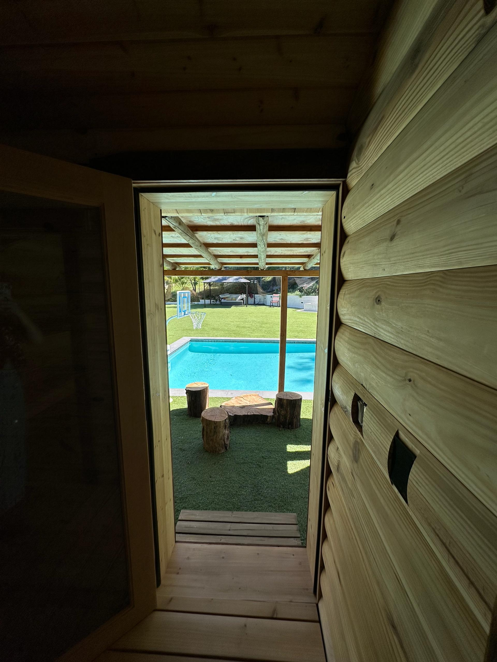 Sauna doorway leading to outdoor pool at wellness spa in Woodland Hills