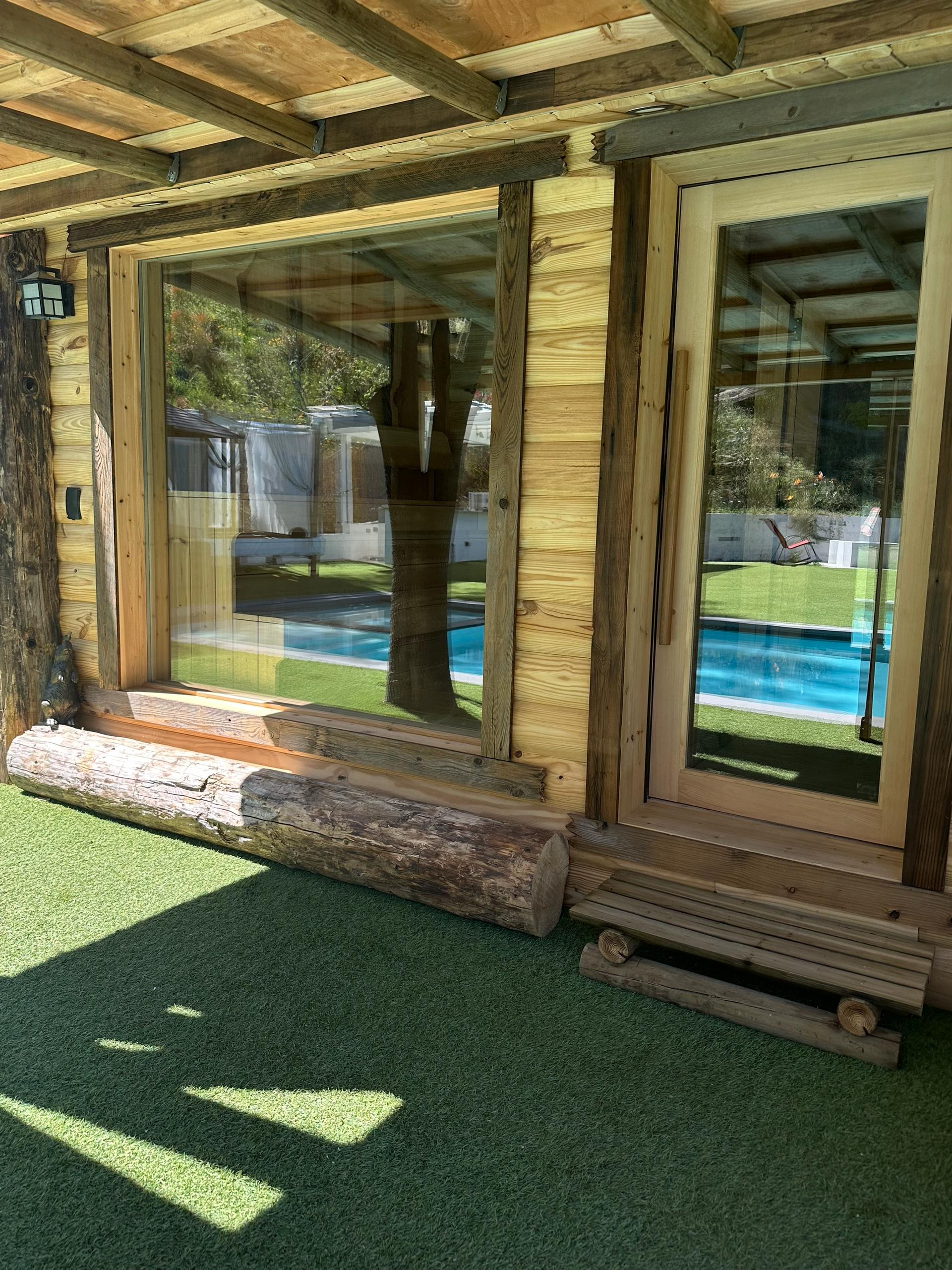 Luxury spa entrance with glass doors and wooden sauna exterior in Woodland Hills