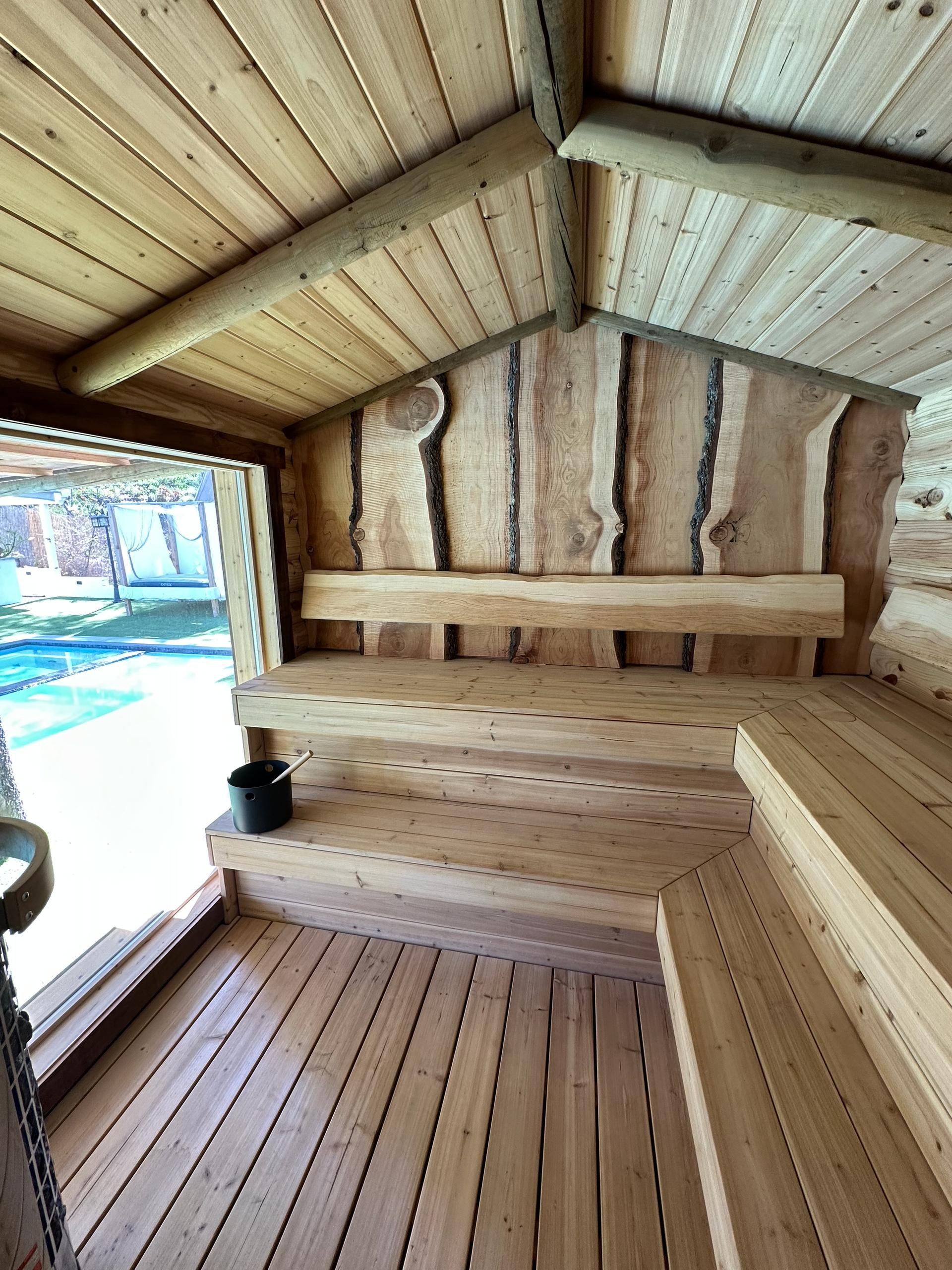Spacious wooden sauna interior with tiered seating in Woodland Hills spa