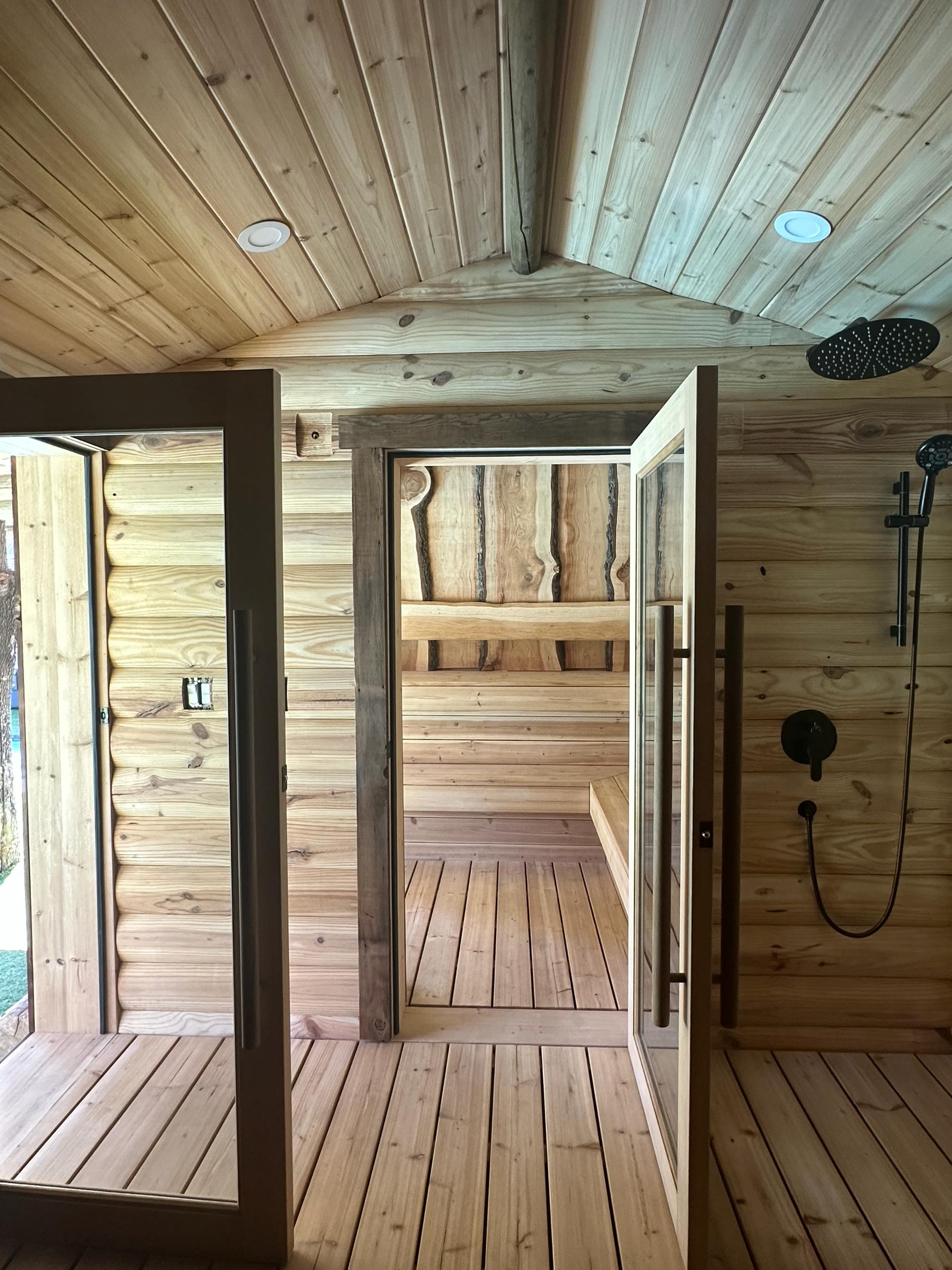 Sauna with glass door and shower setup in Woodland Hills wellness spa